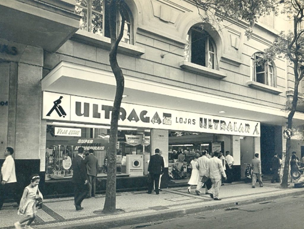Fachada da loja de varejo Ultralar, com pessoas analisando a vitrine.